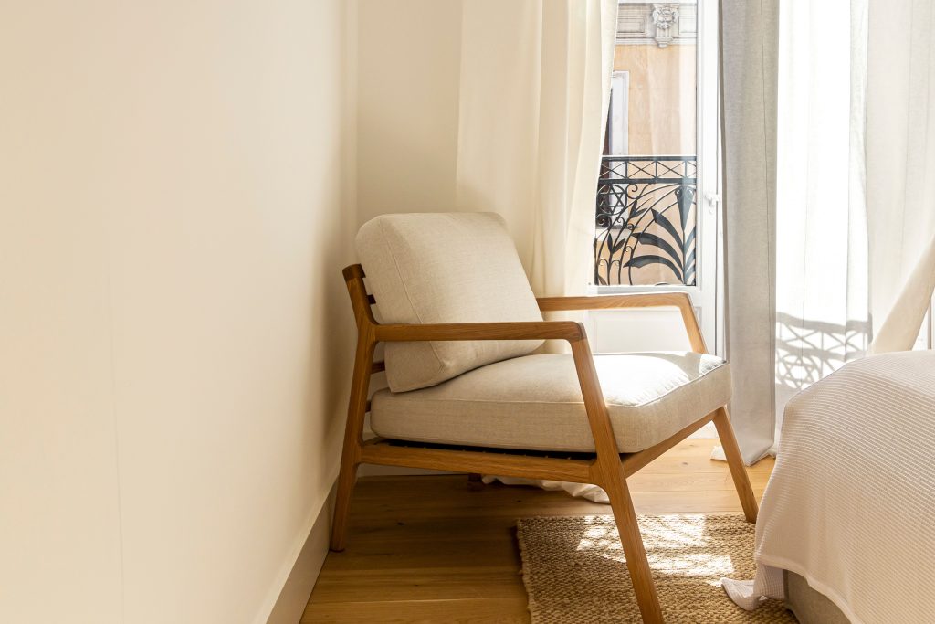 A cozy Scandinavian-style chair in a bright, elegant Madrid interior.